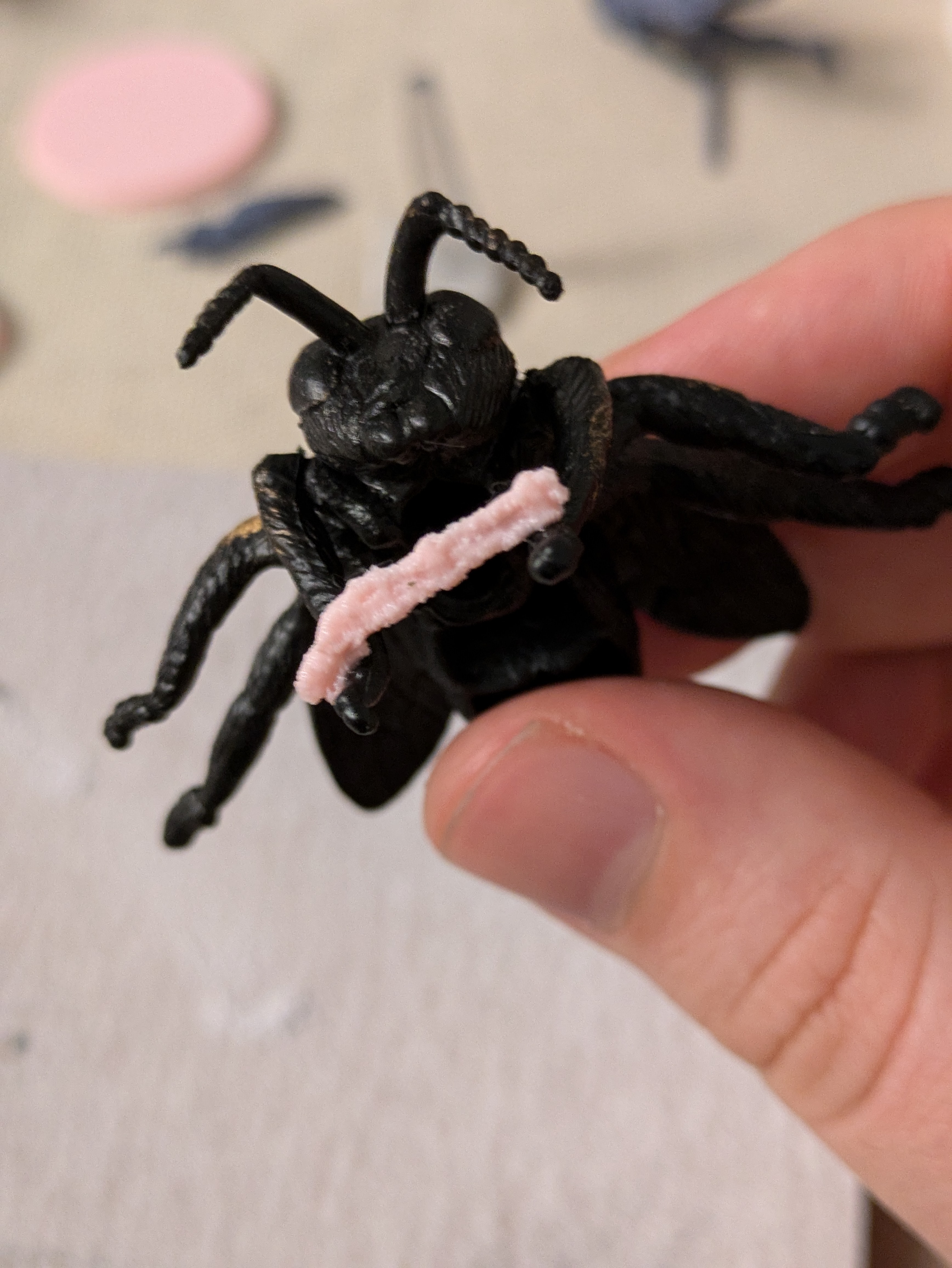 A Trench Crusade model for a Herald of Beelzebub. It is a dollarstore fly model that is carrying a rifle in its' front two legs