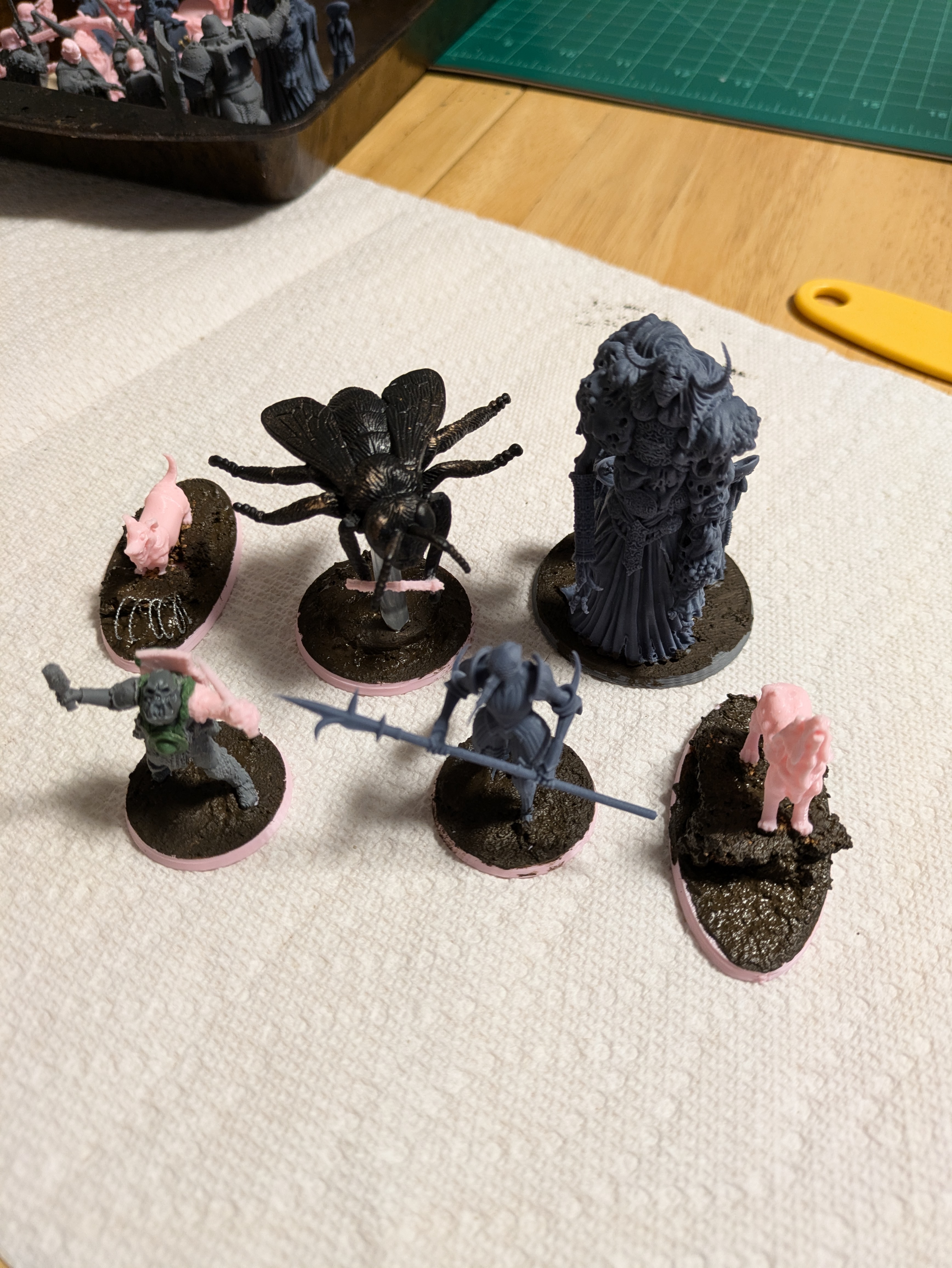 A small Trench Crusade warband, unpainted sitting on a table. Includes Lord of Tumours, Corpse Guard, and Plague Knights